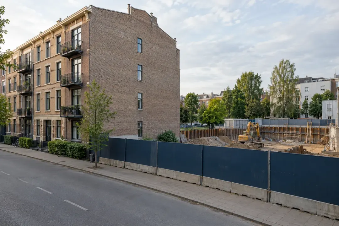 Existing building beside a construction-site boundary.