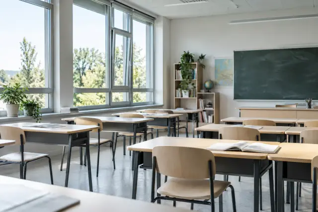 Bright classroom with desks and broad operable windows
