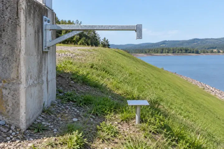 Embankment reference-point movement installation background: The local embankment survey point’s attached target and a visibly separate outside reference.