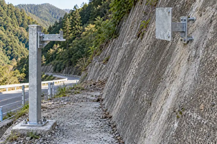 Engineered slope reference targets installation background: An anchored slope target facing a separate reference outside the assessed moving section.
