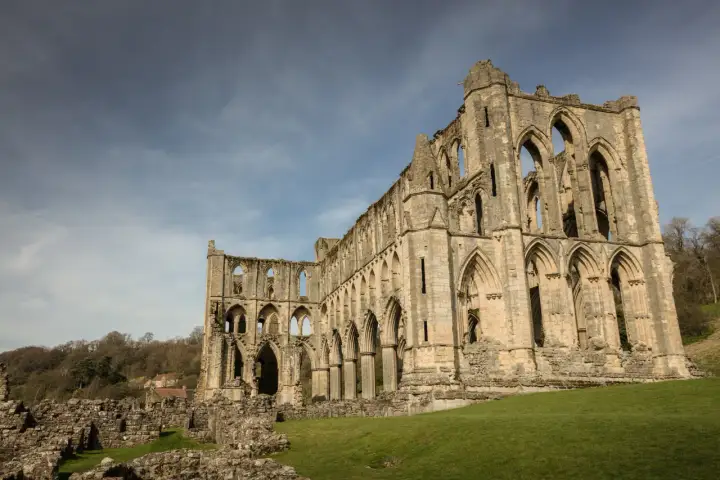 Weathered stone walls and arches at Rievaulx Abbey, England
