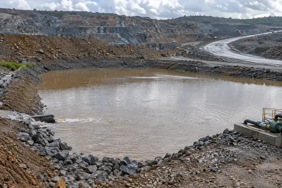 Mine dewatering collection area with a water sump, drainage pipes and an accessible industrial maintenance route
