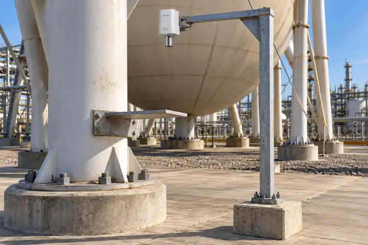 Hitelecom radar sensor on a separately founded reference post pointing down to a broad target fixed to one spherical tank support