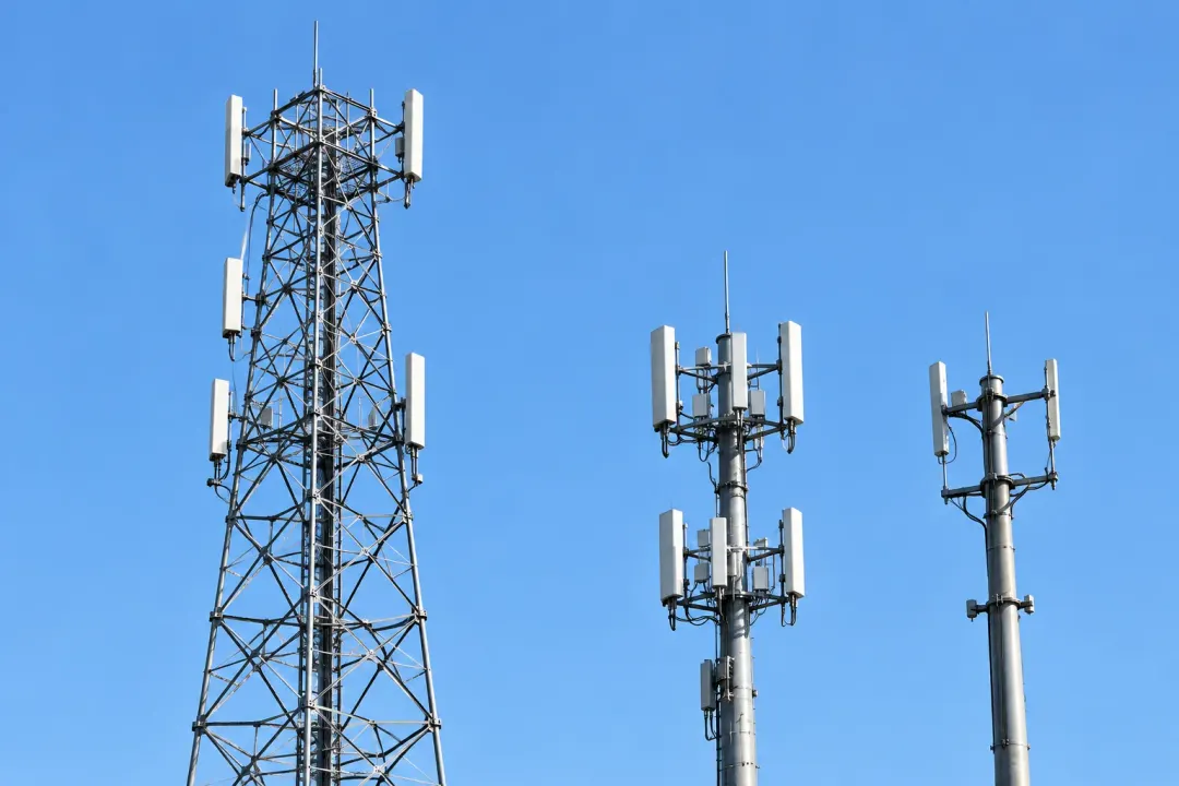 Application illustration: A telecommunications lattice tower with cellular antenna panels against the sky.