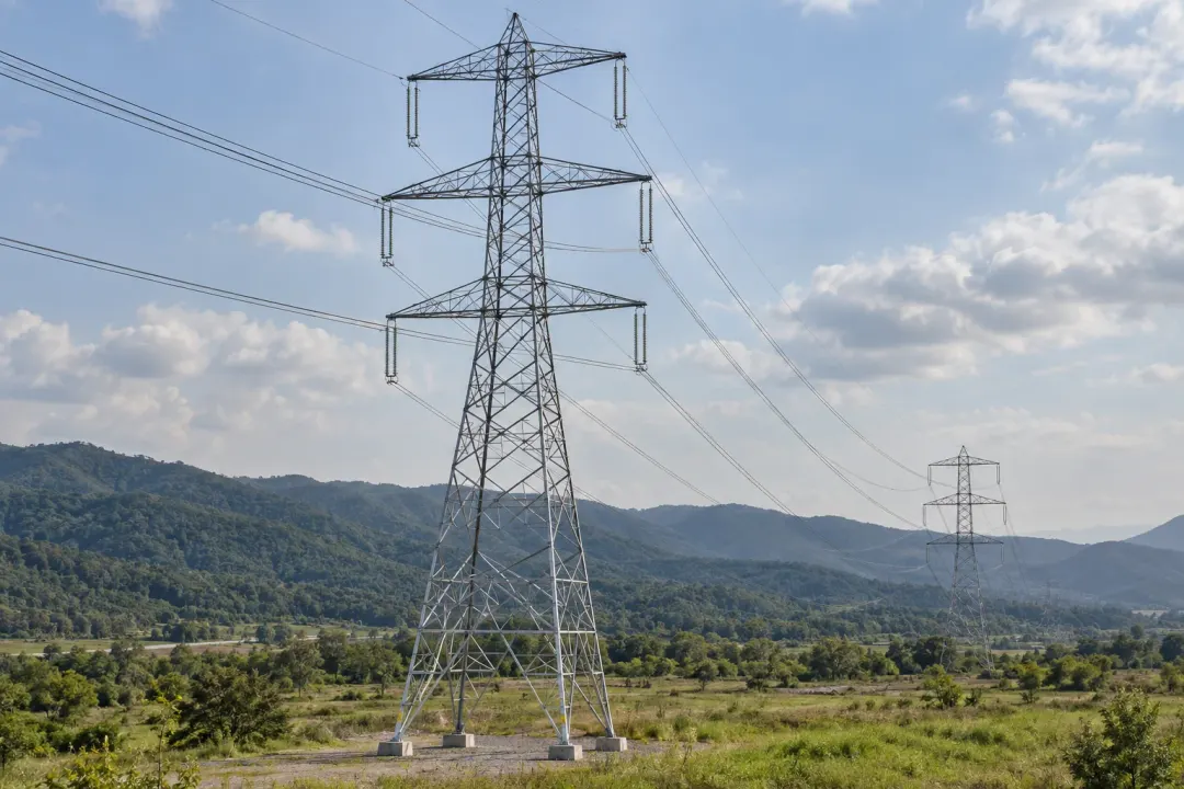 Application illustration: Steel electricity transmission pylons with crossarms, insulators and overhead conductors.