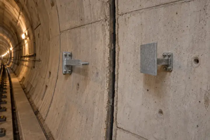 Tunnel construction joint movement installation background: A real joint between two tunnel segments with the broad target and opposing attachment visible.