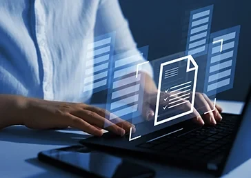 Engineer working on a laptop with digital documents