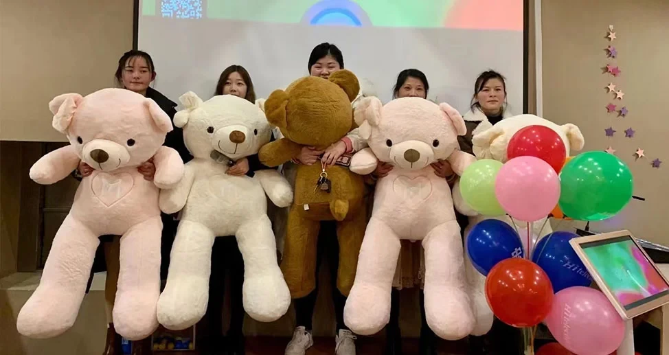 Hitelecom employees celebrating with teddy bears and balloons