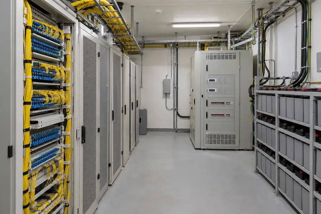 Indoor telecommunications exchange room with fiber distribution panels, rectifier cabinets and battery racks